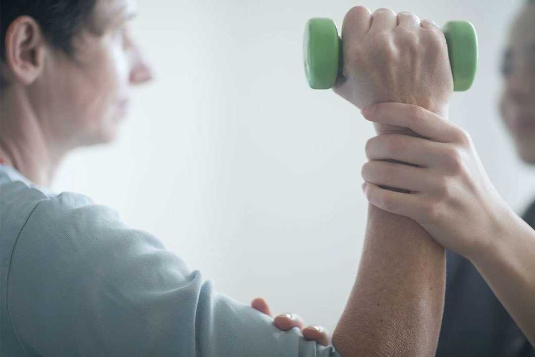 Mann trainiert mit Hantel - Lungenkrebs Kontrolle und Nachsorge